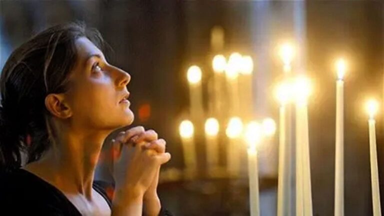 woman-praying-church-candles.jpg