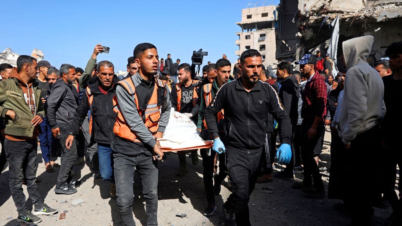 gaza-police-station-airstrike-body-carried.jpg