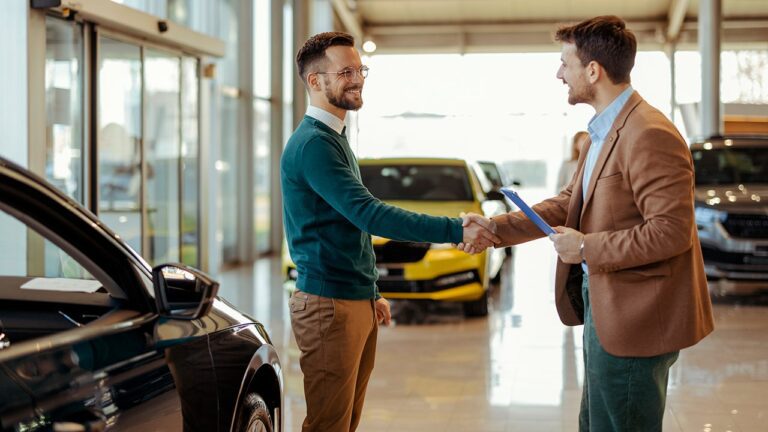 two-men-shaking-hands-car-dealership.jpg