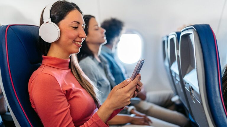woman-looking-at-phone-on-airplane.jpg