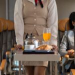 flight-attendant-pushes-cart-with-food-and-drinks.jpg