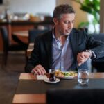 man-checking-watch-eating.jpg