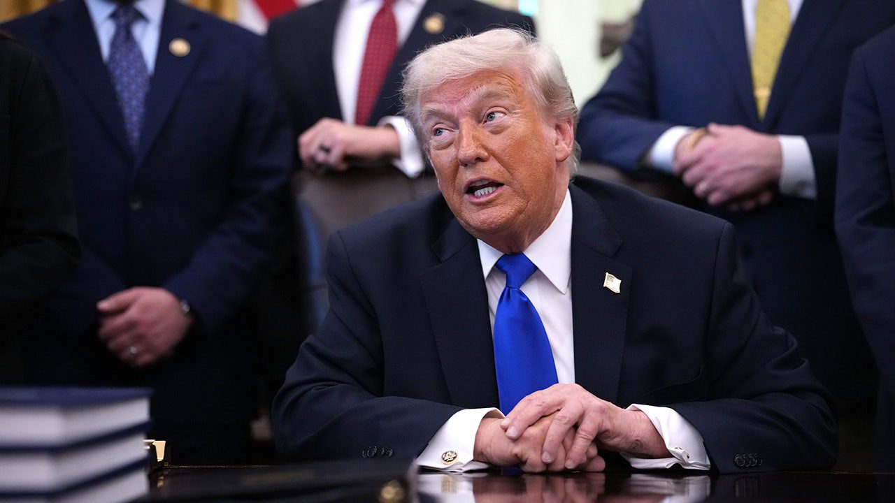 donald-trump-signs-executive-order-with-lawmakers-in-background.jpg