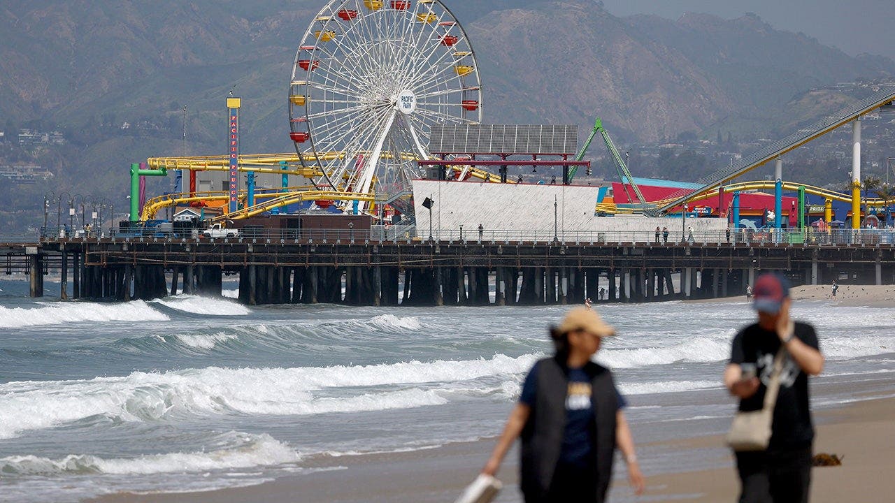 people_walking_on_beach_santa_monica_pier.jpeg