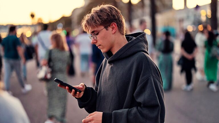 teen-boy-looks-at-smartphone.jpg