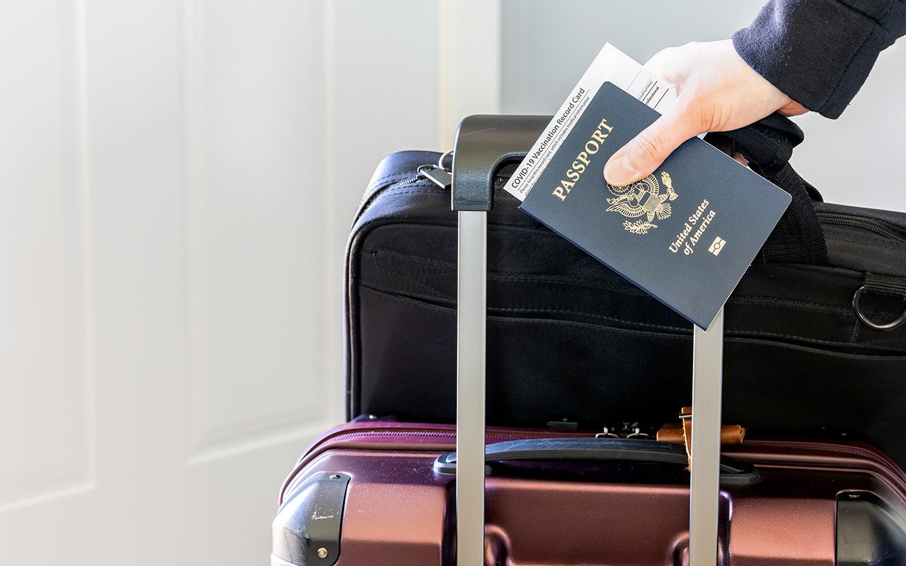 woman-holding-passport-luggage.jpg