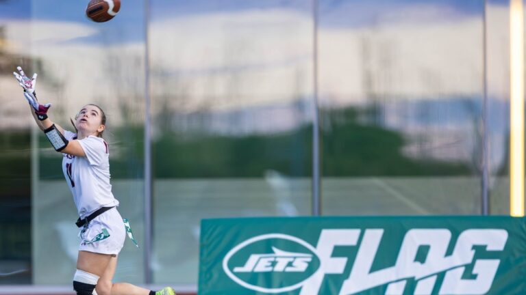 girl-reaches-catch-football-jets.jpg