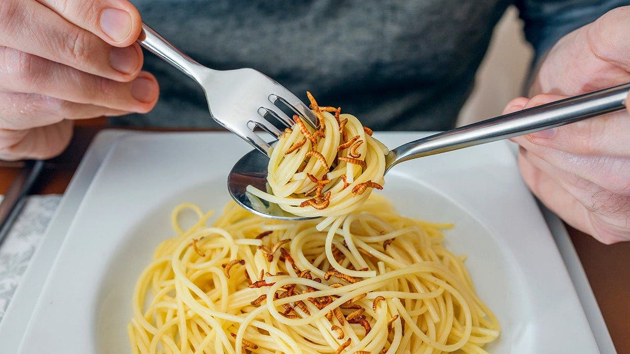 man_eating_crispy_worms_with_noodles.jpeg