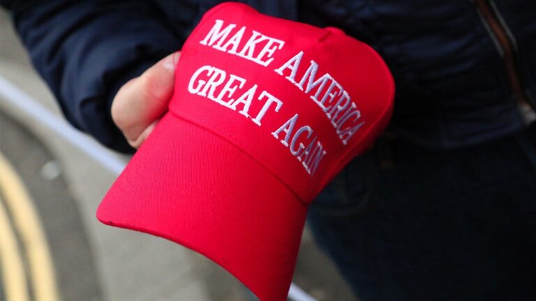 person-holds-MAGA-hat.jpeg
