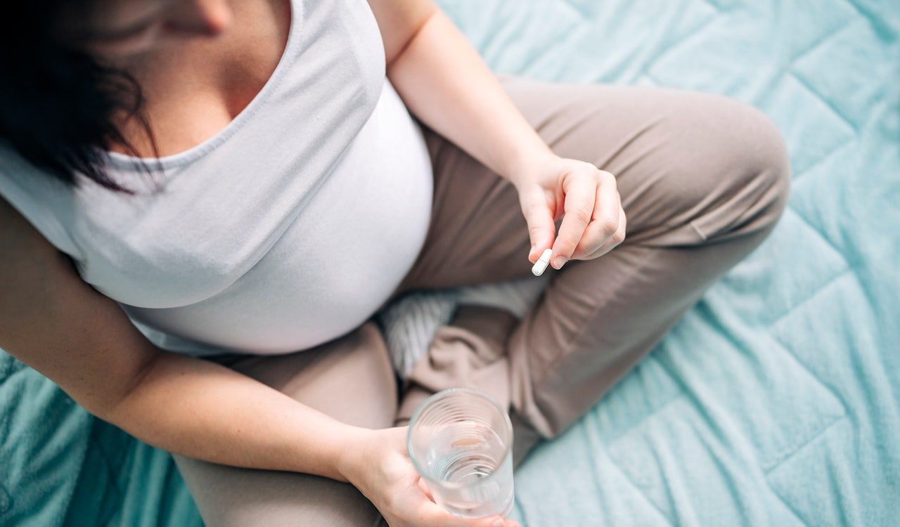 pregnant-woman-taking-pill.jpg