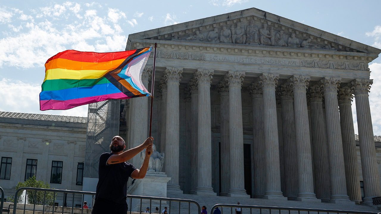 protester-lgbtq-flag-supreme-court-building.jpg