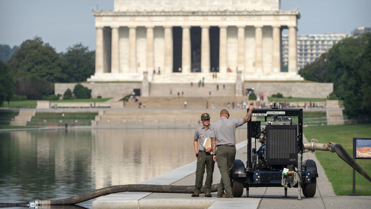 Crews-draining-reflecting-pool.jpg