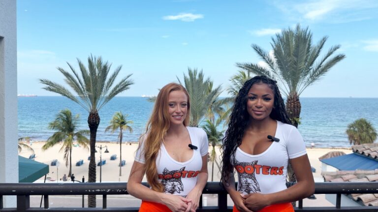hooters-girls-gracie-williams-and-micayla-williams-pose-with-fort-lauderdale-beach-backdrop-1.jpg