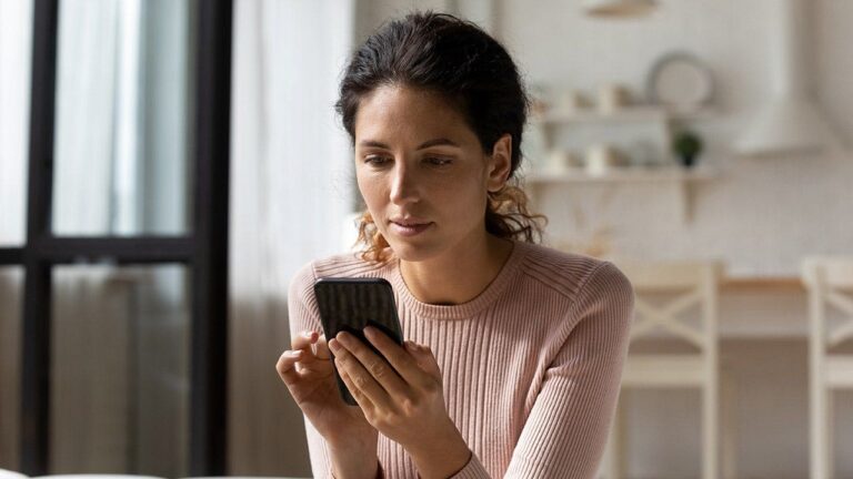 woman-looking-at-phone-sofa.jpg