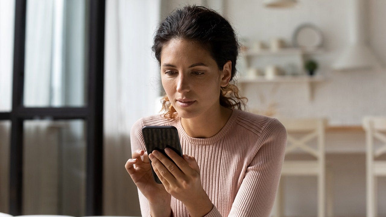 woman-looking-at-phone-sofa.jpg
