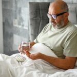 man-taking-medication-bed.jpg