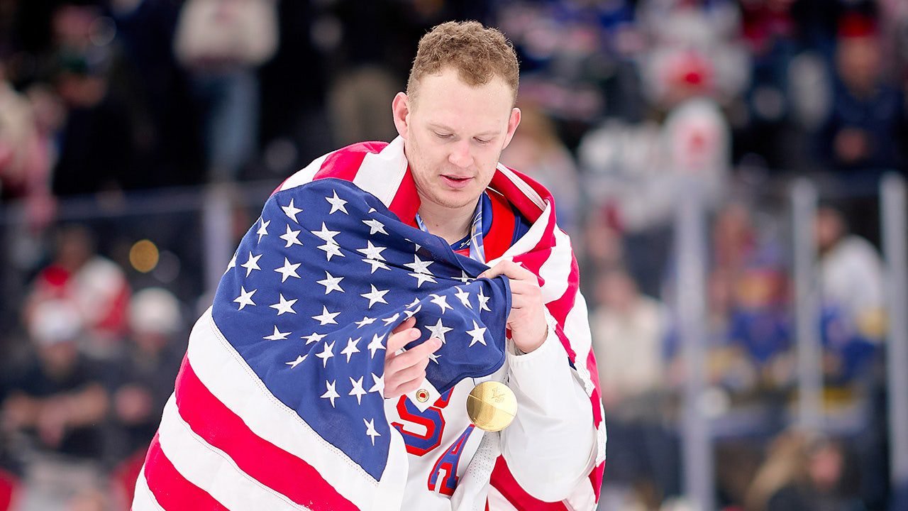 brady-tkachuk-with-medal-usa-flag.jpg