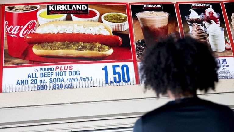 costco-food-court-customer-looks-at-sign-for-kirkland-signature-hot-dog-and-coca-cola.jpg