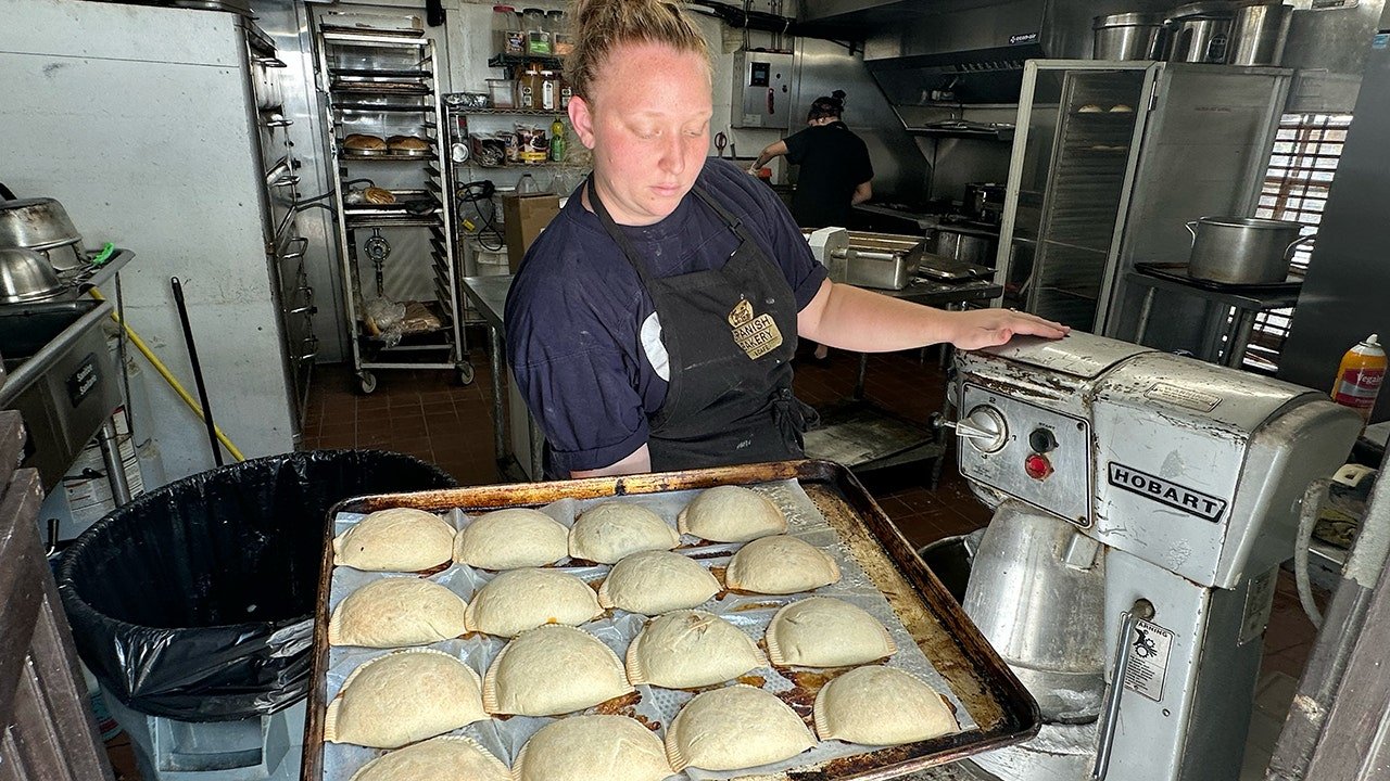 spanish-bakery-manager-holds-tray-of-viral-empanadas.jpg