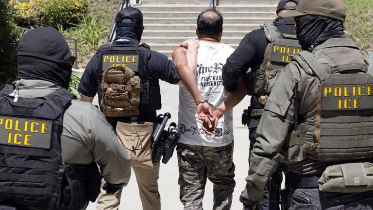 ICE-agents-walk-detainee-july-2026.jpg