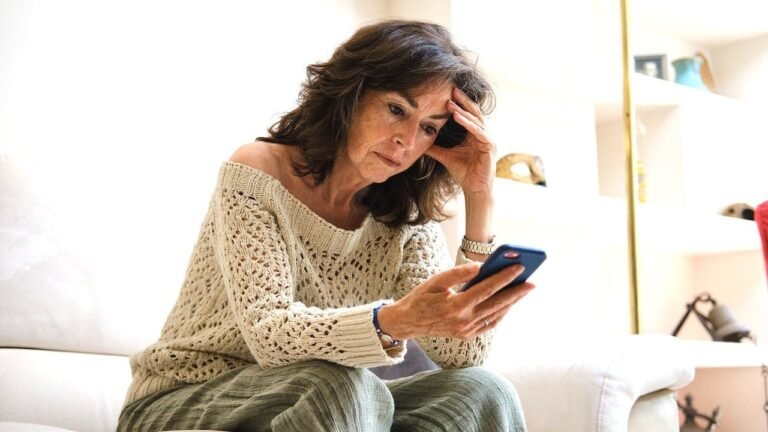 senior-woman-reading-phone-worried.jpg
