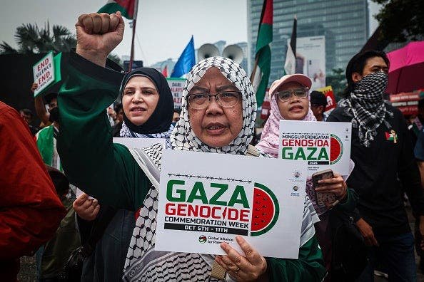 woman-gaza-genocide-placard-kuala-lumpur-rally.jpg